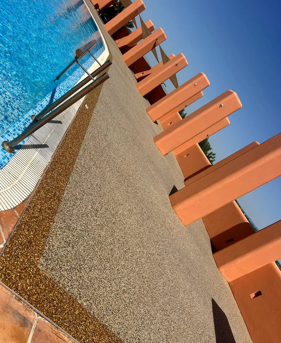 Close view of the warm aggregate finish beside the pool